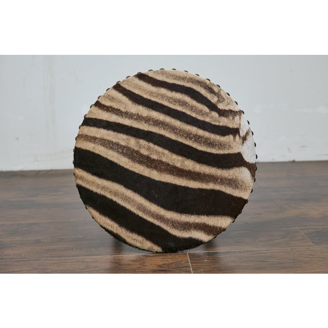 An English faux bamboo side table from the 19th century with faux bamboo base, zebra hide top and X-Form cross stretcher....