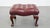 Offered in very good condition, this elegant red/brown Chesterfield footstool is made of cowhide leather. A cowhide...