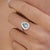 This vintage-style halo cocktail ring features 1 ct of a pear-shaped aquamarine and diamond set in 14k white gold. The...