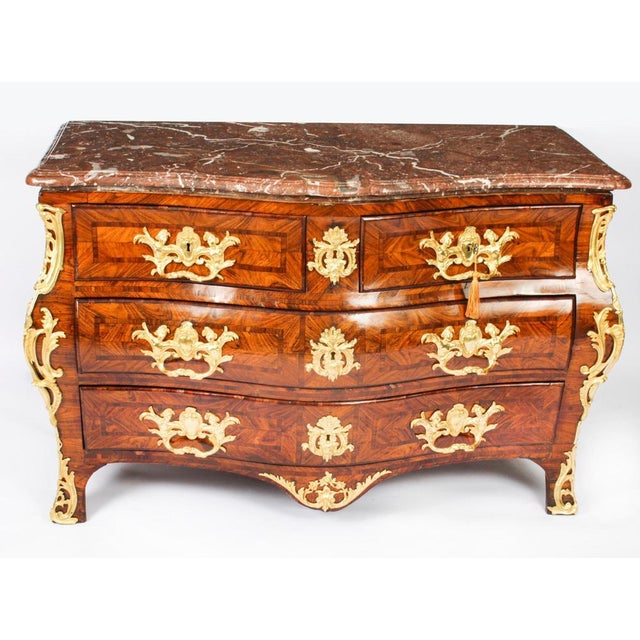 This is an impressive and rare antique french régence wood and ormolu mounted commode, circa 1720 in date. The stunning...