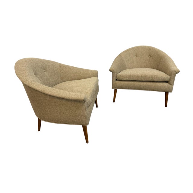 Exceptional pair of Mid-Century Modern barrel back armchairs featuring timeless design inspired by Paul McCobb. These...