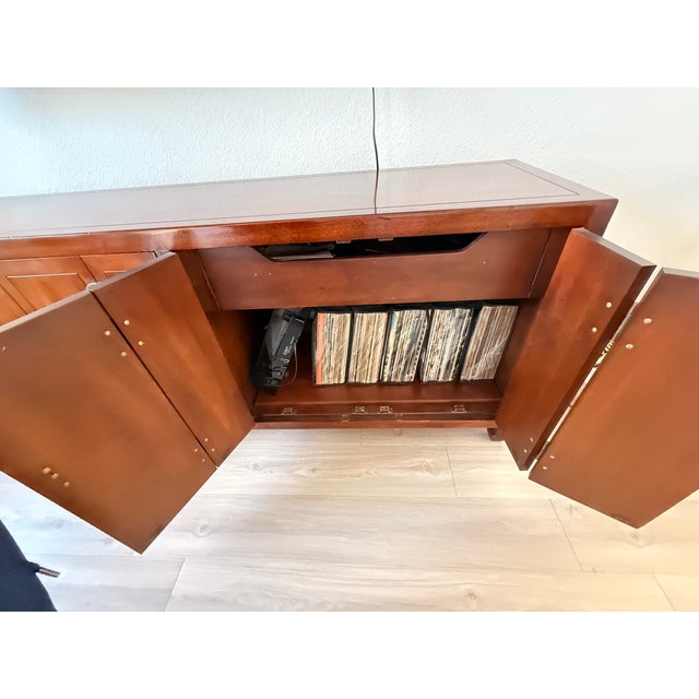 Vintage Henredon Chinoiserie credenza dating to circa the 1970s, crafted in warm walnut with distinctive Asian-inspired...