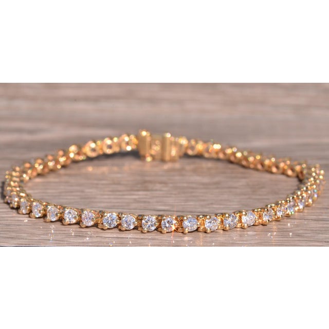 The Valley Center: Yellow Gold Martini Set Diamond Bracelet. The bracelet features three prong or martini set round...