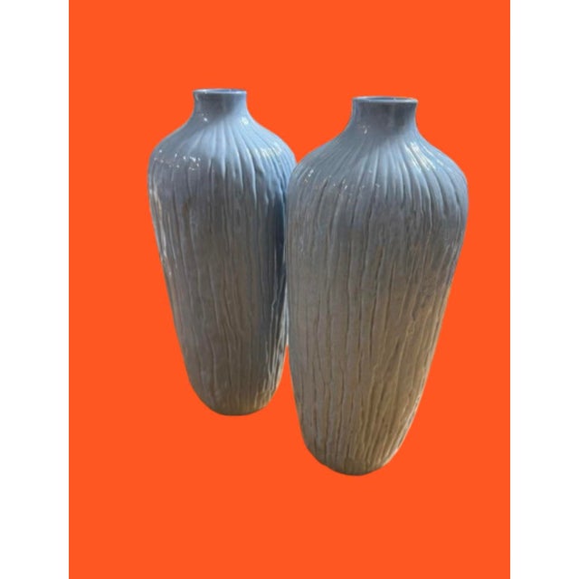 A beautiful pair of blue/grey vases made of ceramic from Portugal slander featuring texture design. Circa 2001-2004