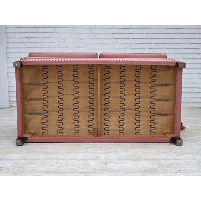 1970s, Danish 2-seater "Spanish" drop arm sofa. Pink furniture wool, ash wood legs. Sofa was reupholstered by craftsman...