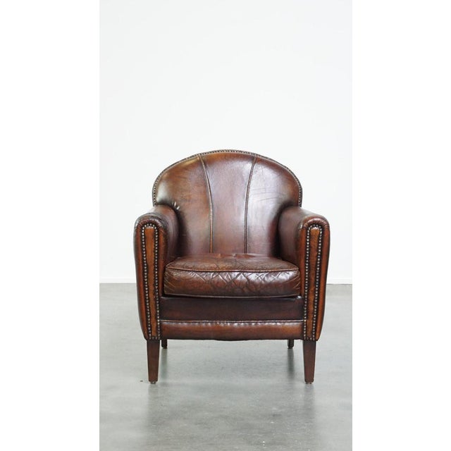 Offered is this characterful vintage design armchair made of beautifully patinated sheep leather. This nice sheep leather...