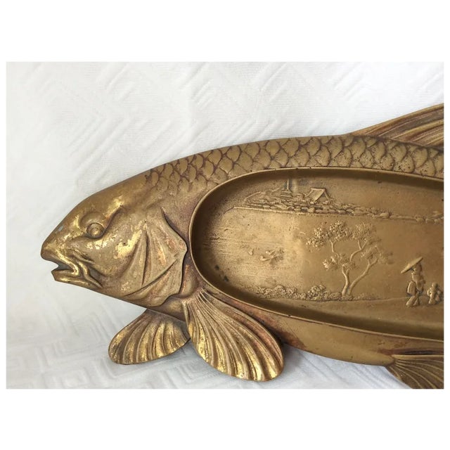 An Antique (circa early 1900s) Bronze Coy Fish Tray. The Tray has an Asian motif in the center and is realistically...