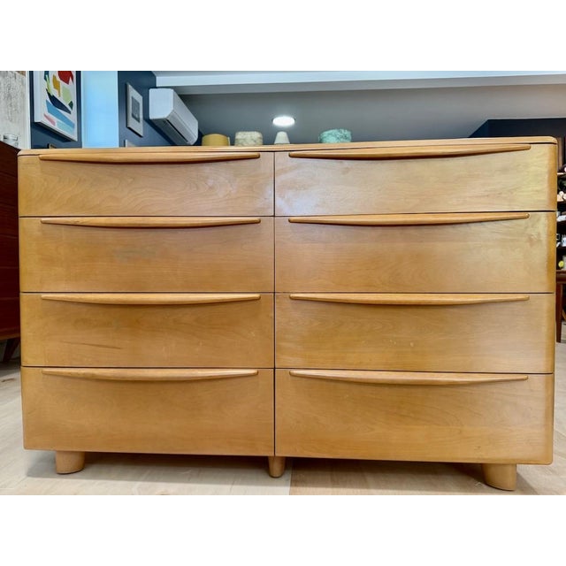 Vintage Heywood Wakefield ‘Encore’ low double dresser features a sleek, rounded silhouette and long tapered drawer pulls....