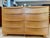 Vintage Heywood Wakefield ‘Encore’ low double dresser features a sleek, rounded silhouette and long tapered drawer pulls....