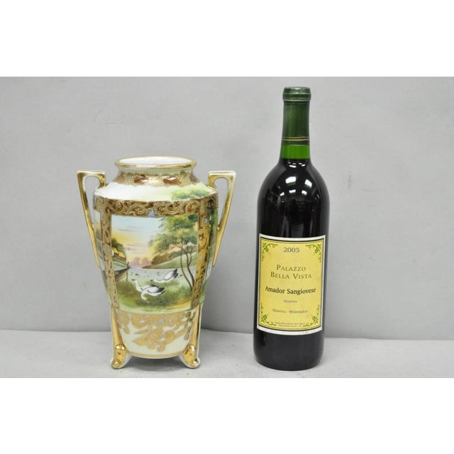 Antique Nippon Hand Painted Porcelain Twin Handled Gold Gilt Footed Vase w/ Swan & Lake Scene. Circa Early 20th Century....