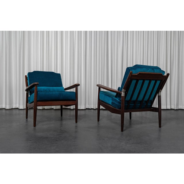 Pair of mid-century Scandinavian teak armchairs, newly upholstered and covered in a petrol blue corduroy by the British...