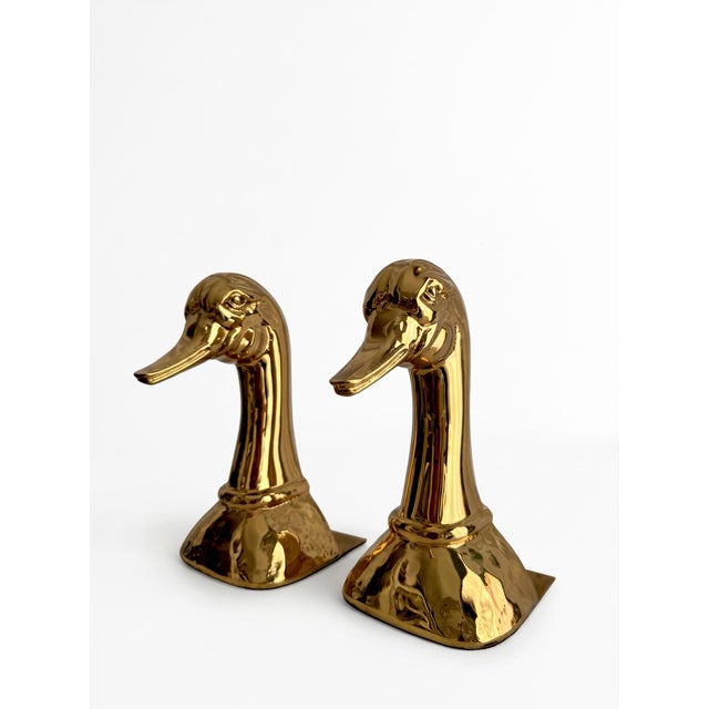 A pair of decorative figures shaped like duck heads, crafted from solid brass. Produced in Spain during the 1970s by...
