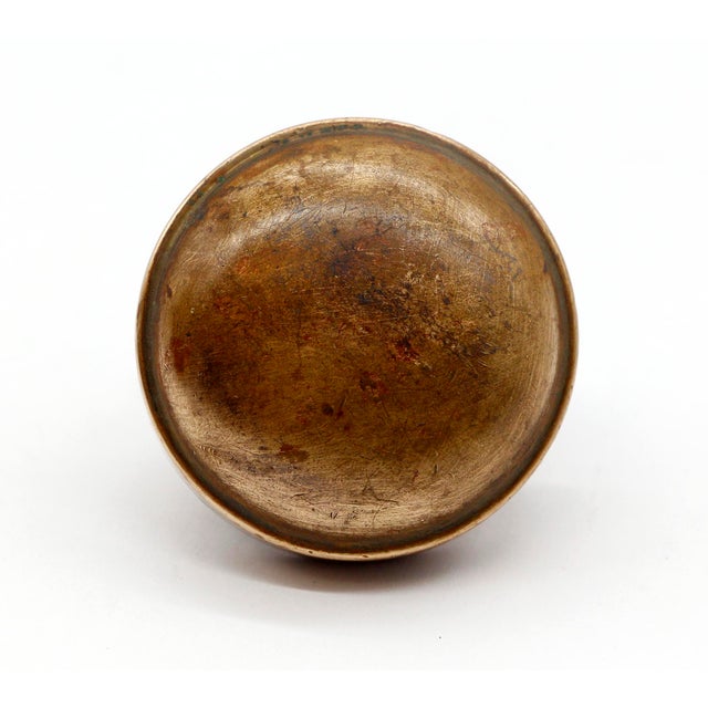 Plain round brass doorknob with an antique patina. The manufacturer and date of creation is unknown. Priced each. The...
