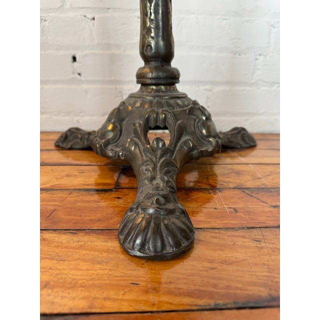 Antique wrought iron bistro chair w/ claw foot. Sits at a slight angle depending on where the seat is rotated to. Please...