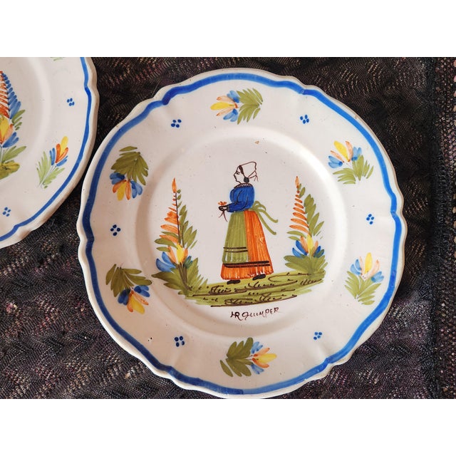Antique french hr quimper in their traditional style of people in a series, a man on one plate and a lady on the other. hr...