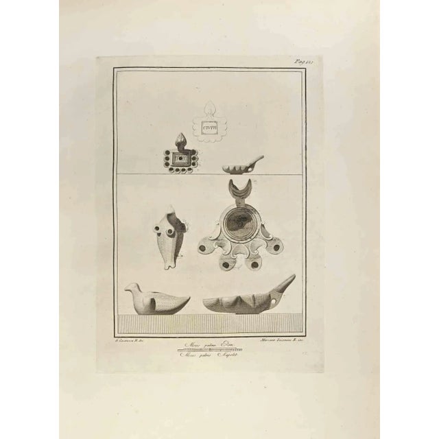 Oil Lamp with Bird from "Antiquities of Herculaneum" is an etching on paper realized by Marcantonio Iacomino in the 18th...