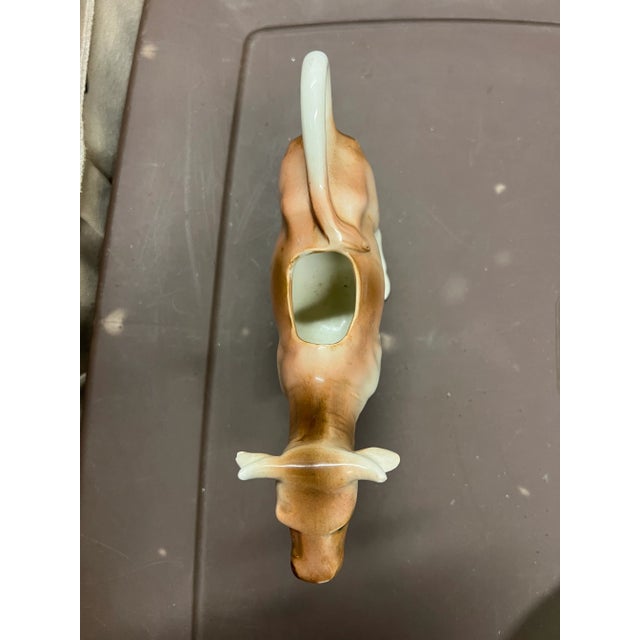 1920s Ceramic cow creamer. Tan ceramic cow measuring 9” wide by 3” and stands 5.5” tall. The milk or creamer pours out of...