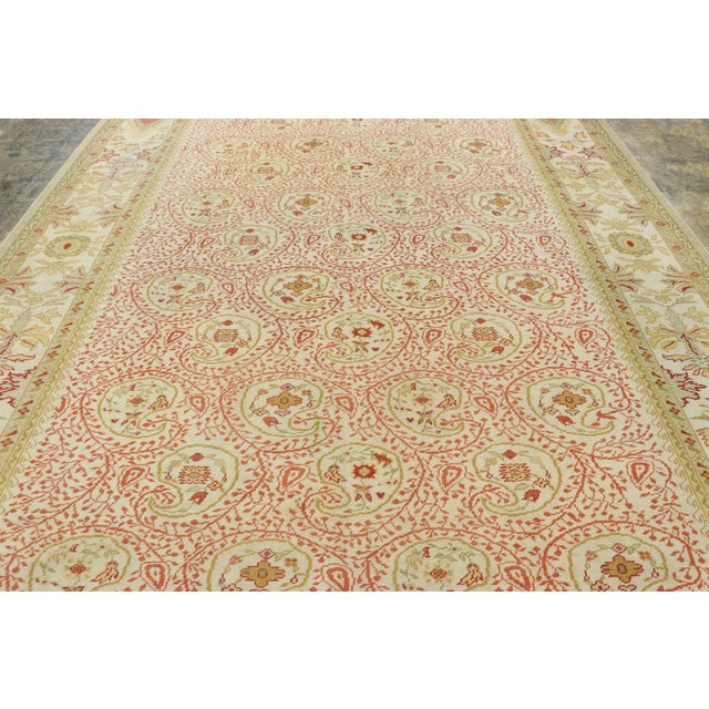 Made with hand-knotted wool and originating from Turkey circa 1980–1990, this 10x14 young vintage Oushak rug is an...