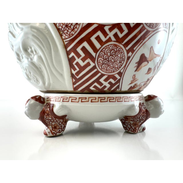 A striking vintage Japanese porcelain incense burner featuring a classic Imari-style palette in iron red and white, richly...