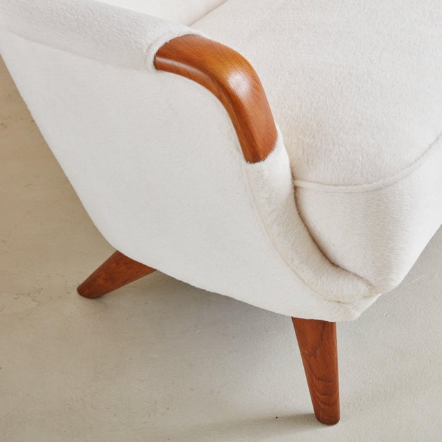 A curvy profile Danish Modern sofa from the 1960s. This stunning piece has been freshly upholstered in a soft, off-white...