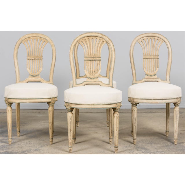 Elegant set of six late 19th century French Louis XVI style dining chairs sourced in Paris, France. The chairs feature...