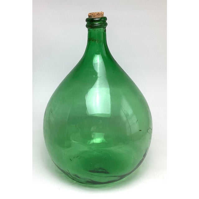 Antique Demijohn Green Glass Bottle in Original Basket. In basket 14” in diameter by 20” tall. Bottle is 11 1/2” by 18”...
