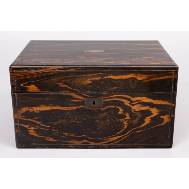 A superb antique 19th-Century English coromandel and rosewood fitted travel vanity or dressing box , circa 1870. This fine...