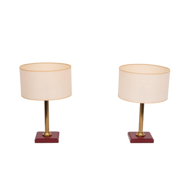 Beautiful set of Table lamps . Red stich Leather base ,Brass column uprights . attributed to Jacques Adnet . 1960s France...