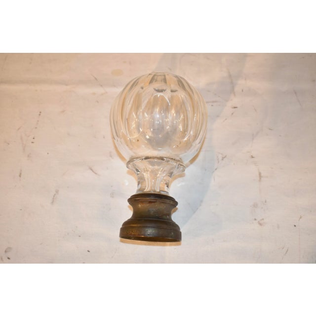 Circa 1900 English Edwardian period cut crystal newel post finial supported on a hand-cast bronze base. This newel post...