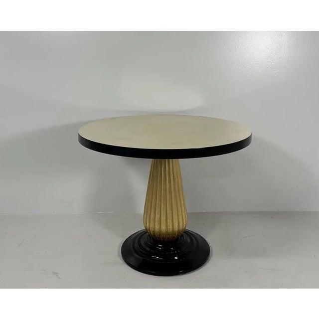 This Art Deco style coffee table was produced in Italy in the 1980s. The top is in parchment with a black lacquered...