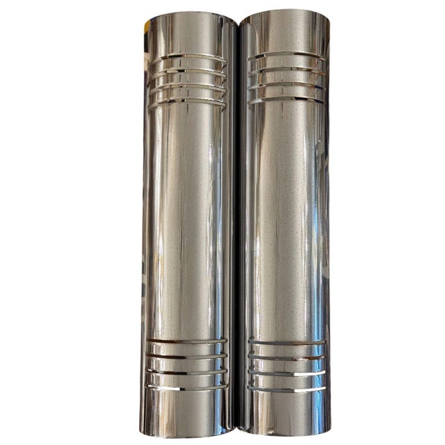A sleek and architectural set of four Italian mid 20th century cylindrical wall sconces, designed with paired vertical...