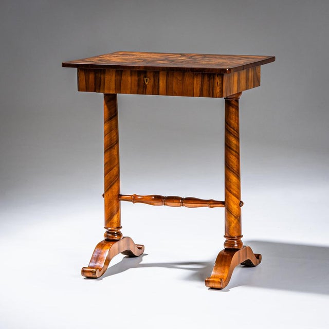 Biedermeier sewing table with a drawer fitted with compartments for small accessories. The top is veneered in mirrored...