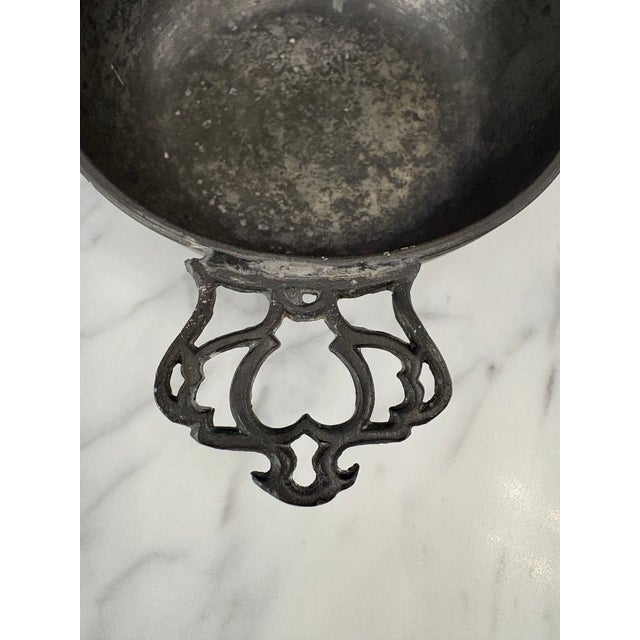 !8th Century English pewter porringer bowl with reticulated handle. Marked on the bottom with England. Appears to be...