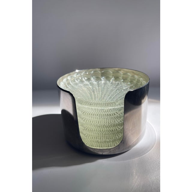 A set of six matching seashell coasters in a silver-plated caddy. -Caddy measures 2 3/4 inches tall and 4 inches wide....