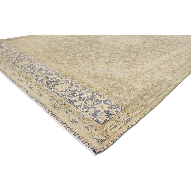 Distressed Antique Persian Kerman rug with Rustic French Country style. With its timeless floral design and rustic...