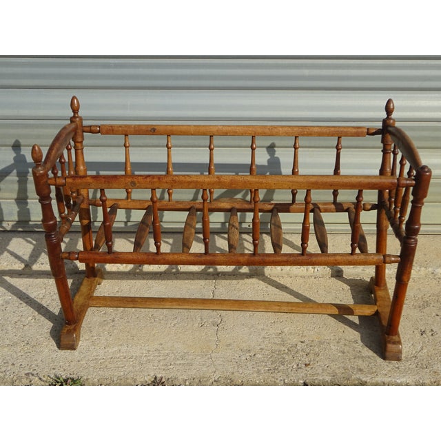 Cradle or small crib with bars, made entirely of solid walnut. The frame is composed of 18 turned wooden bars. 7 bars form...