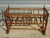 Cradle or small crib with bars, made entirely of solid walnut. The frame is composed of 18 turned wooden bars. 7 bars form...