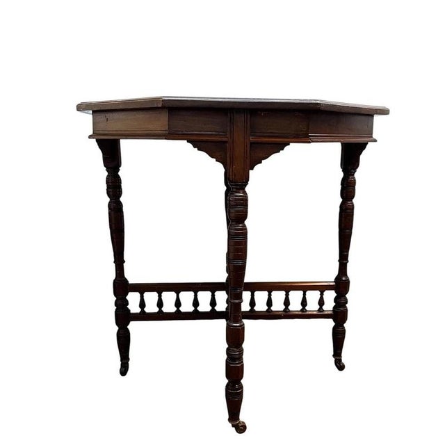 A fine English mahogany occasional table dating to circa 1900, designed in the distinctive Aesthetic Movement tradition....