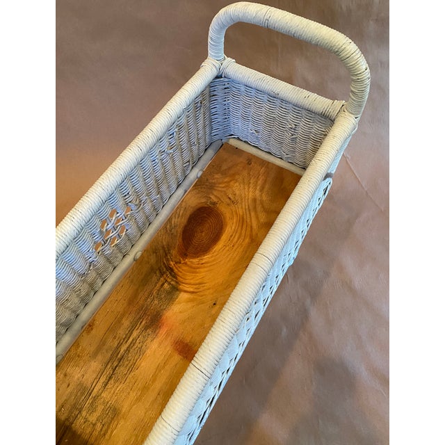 Elegant wicker plant stand with handles, well-made and sturdy enough to hold multiple plants.