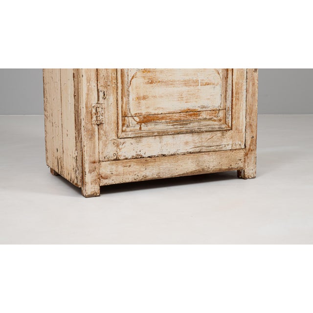 Crafted in the 19th century, this French wood-patinated cabinet embodies rustic elegance with its naturally distressed...