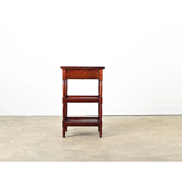 Dimensions: 29 ⅛” H x 18 ⅛” W x 18 ⅞” D A French mahogany and gray marble rafraîchissoir table from the late 19th century....