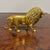 This vintage brass lion figure showcases impressive craftsmanship with intricate detailing, particularly in the flowing...