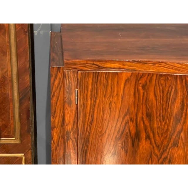 This Period French Art Deco Rosewood Bar Cabinet is a luxurious and stylish piece of furniture perfect for any home....