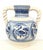 About A striking Spanish glazed earthenware two-handled blue and white painted urn with foliate molded handles, the body...