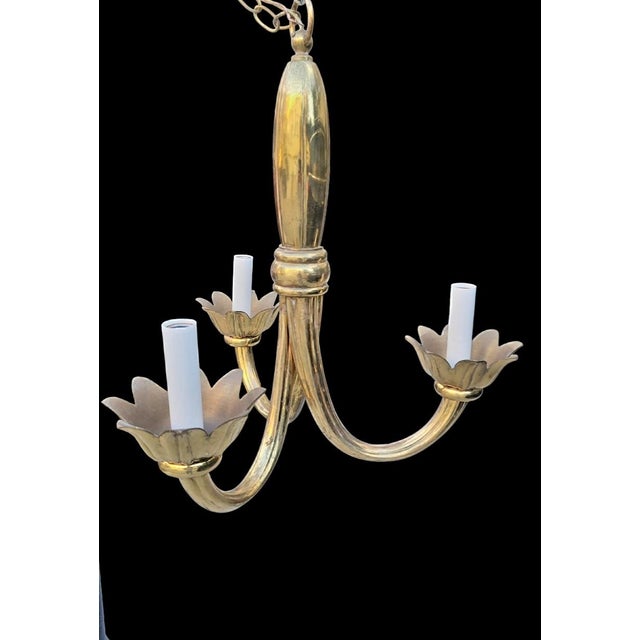 A wonderful very rare solid brass 3 arm lotus flower chandelier by Feldman. The fixture features 3 sort of twisted arms...