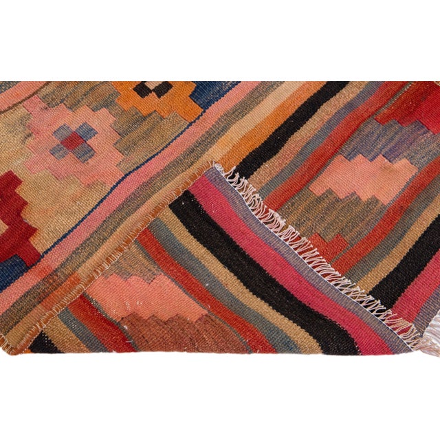 Beautiful vintage Turkish Kilim hand-knotted wool rug with a peach field. This piece has multicolor accents in an all-over...