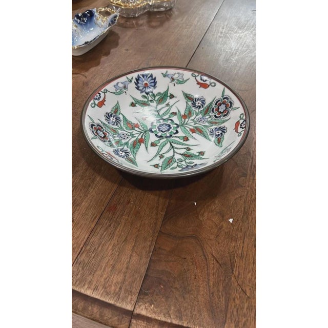 Brighten your decor or dining collection with this striking hand-painted Turkish ceramic shallow bowl. Rendered in...