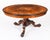 This is a stunning and rare antique Victorian dining set comprising a marquetry loo table with a set of six Victorian...