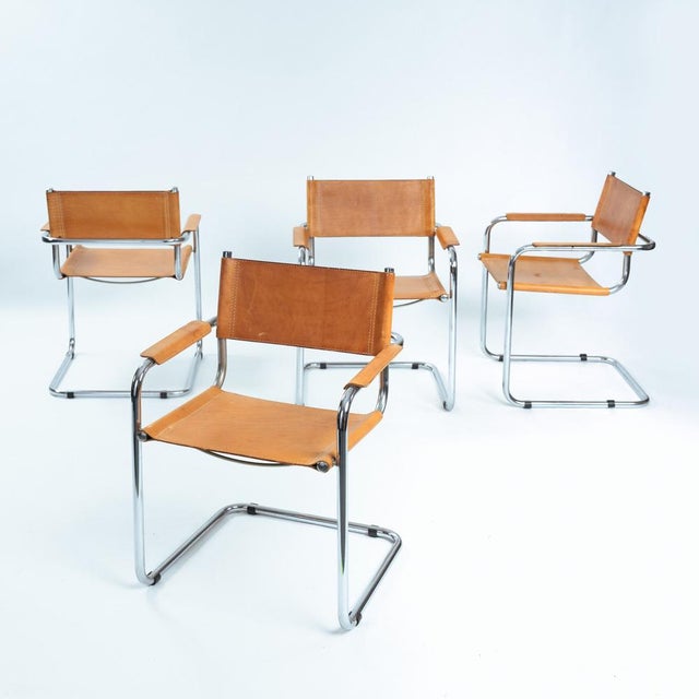 Set of 4 cognac brown cantilever chairs in remarkable condition. The chair is known for its floating “cantilever”...