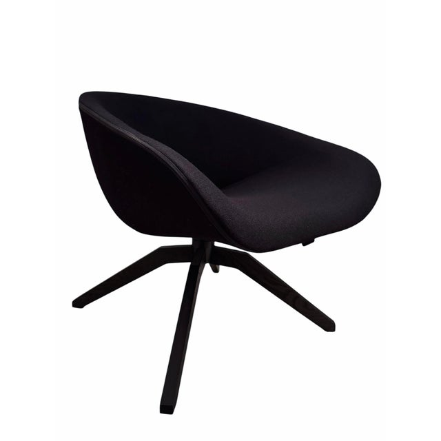 Antonio Citterio swivel armchair with a cozy concave shape resting on a trestle base. So hard to find, especially in such...